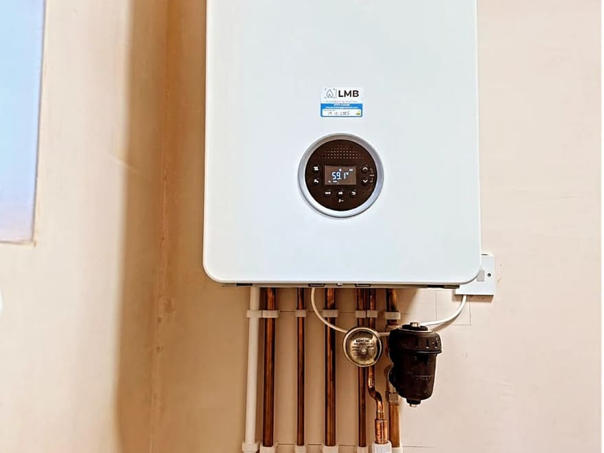 Worcester combi boiler installed by Lloyd, dated commissioning sticker visible on the case