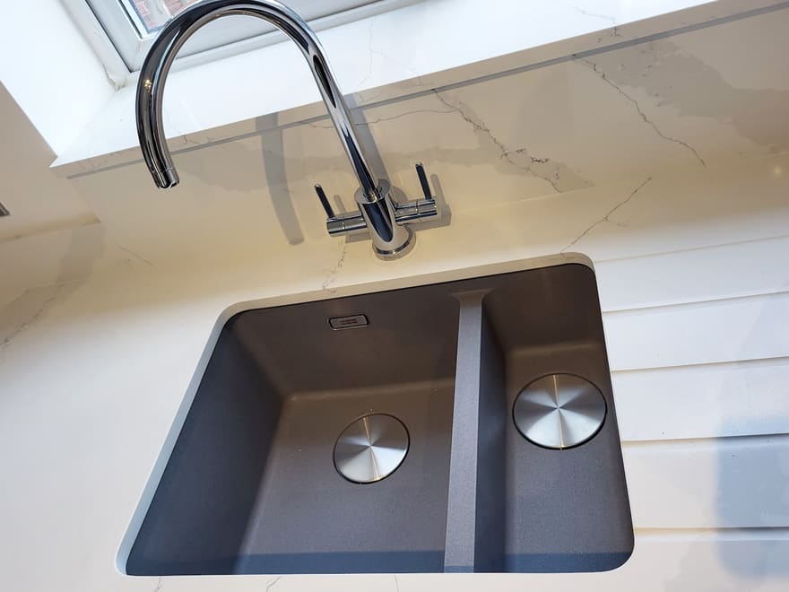 Undermount kitchen sink and chrome mixer tap fitted by Lloyd in a quartz worktop